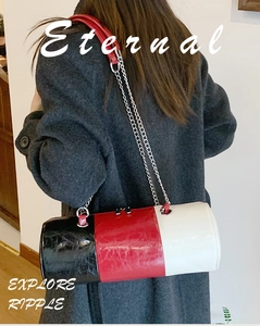 Detail view of tri-color cylindrical bag with pebbled leather and silver chain strap