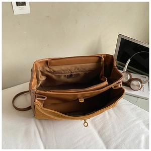 Interior view of large faux suede tote bag showing spacious compartments and zip pocket