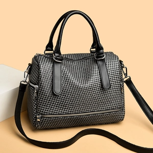 Chic houndstooth pattern boston bag with black leather handles and adjustable shoulder strap