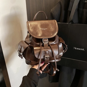 Minimalist dark brown leather backpack with multiple pockets for daily commuting
