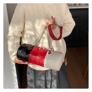 Detail of tricolor cylindrical bag with pleated leather texture and metal chain strap