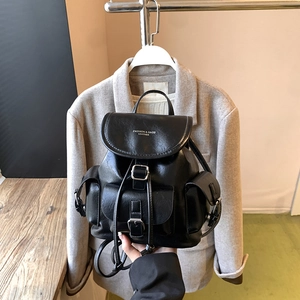 Minimalist black leather backpack with flap closure and front pocket for daily commute