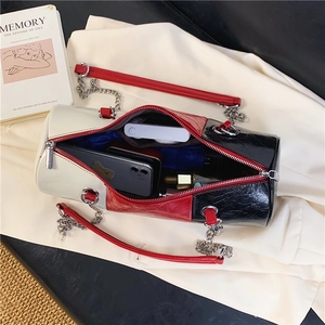 Interior view showing the large storage capacity of this tricolor cylindrical shoulder bag