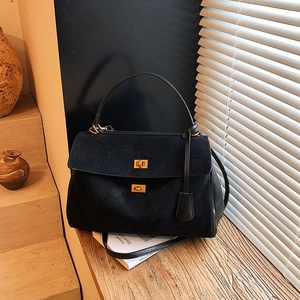 Large black suede handbag with gold twist-lock and top handle for commuting