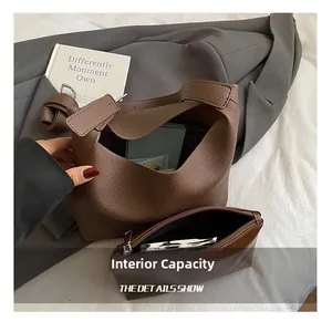Detailed interior of brown pebbled leather bucket bag showing large capacity and inner pouch
