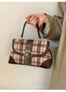 Detail of retro plaid handbag with brown leather trim and a golden ring buckle