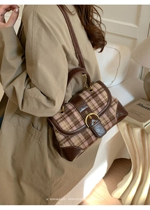 Detail of vintage contrast plaid handbag with leather patchwork and gold metal hardware