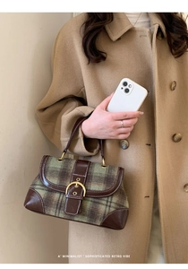 Close-up of retro plaid handbag in green and brown wool with leather details