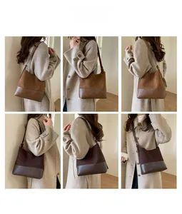 Détail du sac seau en daim montrant la bandoulière réglable et la texture du cuir