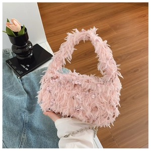 Detailed close-up of pink feather handbag with sparkling sequins and silver metal chain