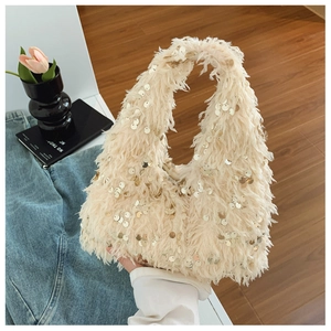Detail shot of a furry cream handbag with gold sequins and a stylish chain handle
