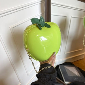 Creative fluorescent green apple-shaped shoulder bag with metallic chain and leaf detail