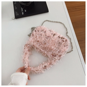 Detail of pink fuzzy faux fur evening bag with sequins and silver chain strap