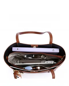 Interior detail of large brown leather tote bag showing spacious compartments and storage