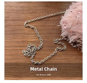 Detailed close-up of pink fluffy feather bag with sequins and silver metal chain