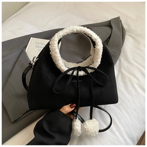 Cute black and white contrast plush handbag with lamb wool handle and fuzzy pom pom charms