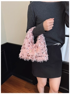 Detail of pink faux fur handbag with sparkling sequins and chain strap for evening events