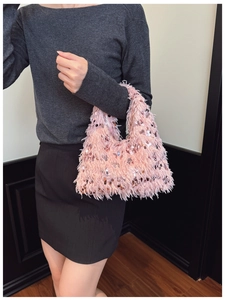 Detail of pink furry evening bag with sparkling sequins and elegant chain strap