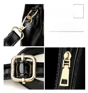 Detailed macro view of gold metal hardware and premium black leather texture on handbag