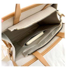 Detail shot of canvas tote bag interior with main compartment and zipper pocket