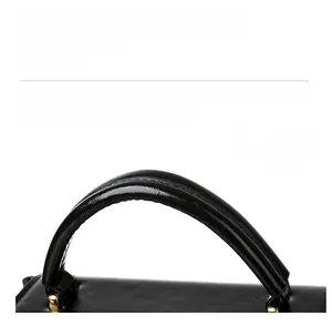 Detailed close-up of durable black leather tote handle with sturdy gold D-ring hardware