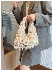 Detailed texture of ivory sequined faux feather handbag with sparkling silver chain strap