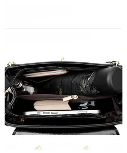 Internal view of a black leather handbag showing multi-layer compartments and large capacity