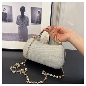 Silver glitter evening clutch with gold metal frame and spherical jewel clasp detail