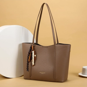 Brown lychee leather tote bag with vintage boho charm and golden embossed text