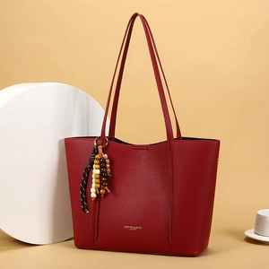 Deep red vintage leather tote bag with elegant tassel detail for women's daily commute
