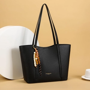 Minimalist black pebble leather tote bag with vintage wooden beads and shoulder straps