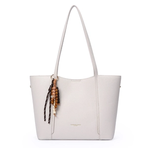 Minimalist beige pebble leather tote bag with elegant wood bead tassel and gold lettering