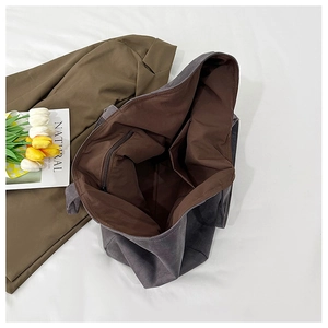 Detail shot of canvas tote interior with zipper pocket and brown lining texture
