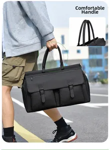 Detail of comfortable padded handles on a black waterproof nylon business travel bag