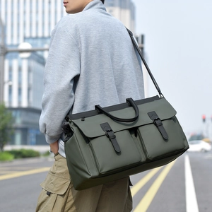 Outdoor shot of army green large canvas travel bag with buckled front pockets for men