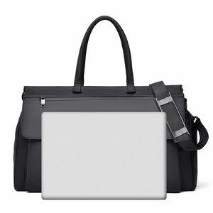 Spacious black travel bag showing large capacity with laptop for size comparison