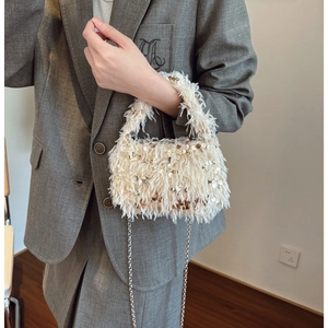 Chic cream faux fur handbag with gold sequins and silver chain for evening wear