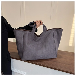 Close-up of grey faux suede tote bag with large capacity and soft matte texture finish