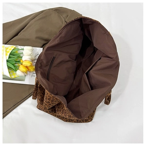Detailed view of leopard print tote bag interior with zipper pocket and lining