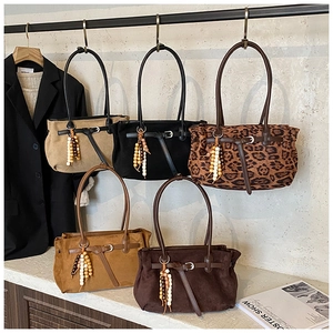 Selection of suede dumpling bags in various colors with retro wooden bead tassels