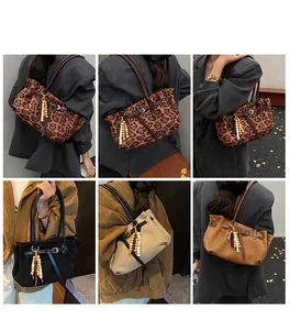 Detailed views of leopard print and solid faux suede shoulder bags with beaded tassels
