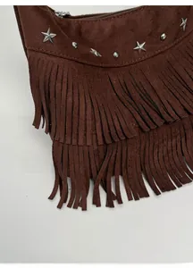 Detail of dark brown suede bag featuring tiered long tassels and silver star metal rivets