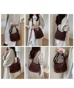 Detail view of coffee suede shoulder bag with star rivets and boho fringe accents