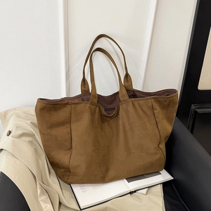 Brown leopard canvas tote bag with large capacity for women on elegant leather chair