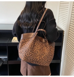 Detailed view of the leopard print faux suede tote bag showing large capacity and leather straps