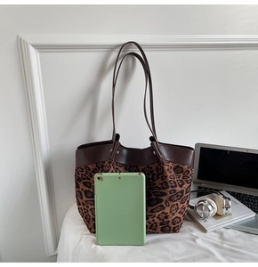 Spacious leopard print tote bag holding a tablet and laptop to show large capacity
