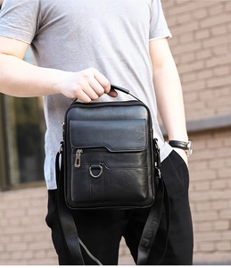 Detailed view of black PU leather messenger bag with adjustable Jeep logo shoulder strap