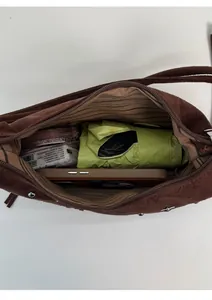 Top view of brown suede bag interior showing capacity for umbrella, phone, and cosmetics