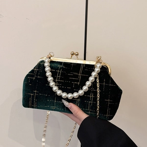 Green velvet shell handbag with gold lattice pattern and elegant pearl handle