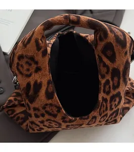 Detail of leopard print plush tote bag showing large interior space and soft texture